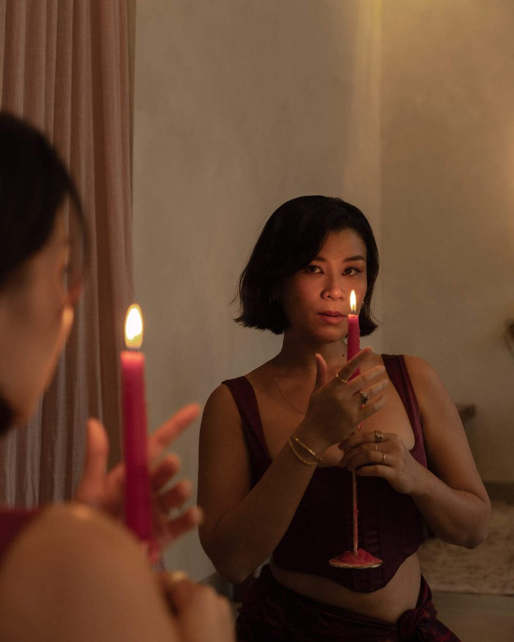 Nadia Rose holding a lit candle